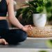 Close-up of a young woman in black clothes doing yoga in a modern gym.The concept of health